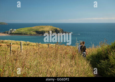Walkers on the cliffs overlooking Burgh Island, The South Hams, Devon, UK Stock Photo