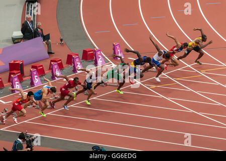 Competitors in Men's 110m hurdles semi-final leave starting blocks, London 2012 Stadium, Summer Olympic Games, London, UK Stock Photo