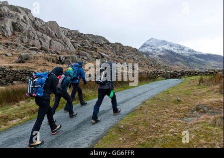 Hikers set off from Pen Y Pass in winter to climb Mount Snowdon in Snowdonia National Park, Gwynedd, Wales, United Kingdom Stock Photo
