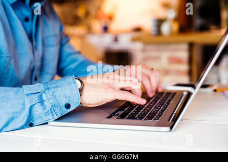 Unrecognizable man working from home on laptop Stock Photo