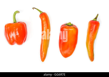 four red peppers of different shapes on white background Stock Photo