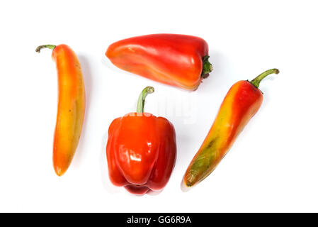 four red peppers of different shapes on white background Stock Photo