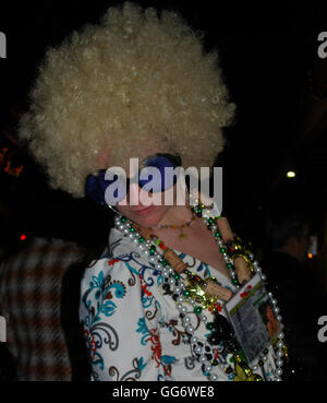 Extravagantly bewigged woman celebrating on Bourbon Street in New Orleans Louisiana United States of America Stock Photo