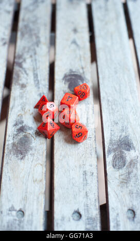 Group of different red role play baord game dice close up on wooden table Stock Photo