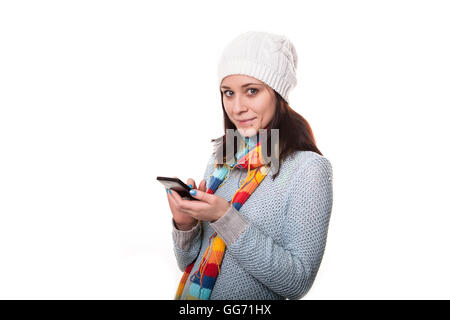 Young beautiful woman writes an SMS to your mobile phone Stock Photo