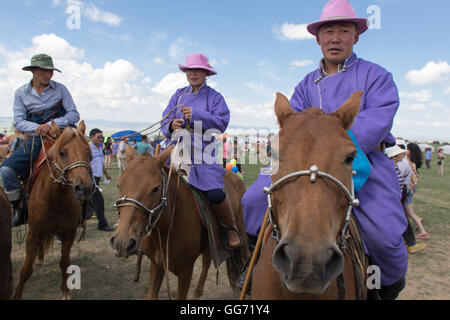Mongolian horsemen in pink hats Stock Photo