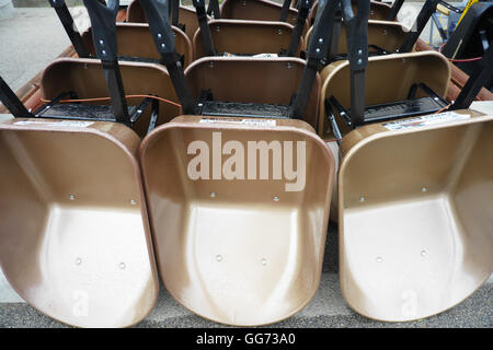 Wheelbarrows on display for sale at a home and garden center in the springtime. Stock Photo