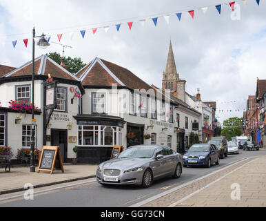 The main street through the New Forest town of Lyndhurst, Hampshire, UK is always a busy one. Stock Photo