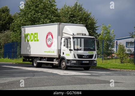 Yodel delivery driver and vehicle en-route in Preston, Lancashire, UK Stock Photo