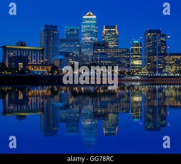 Illuminated Canary Wharf, financial hub in London in the evening Stock Photo