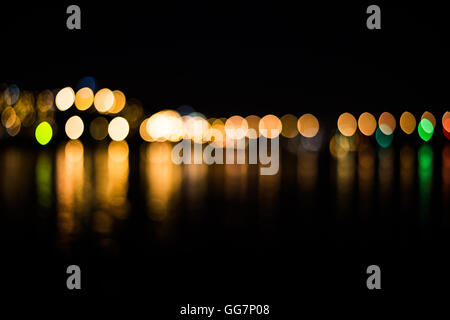 Bokeh of street light in the city with reflection on the river Stock Photo