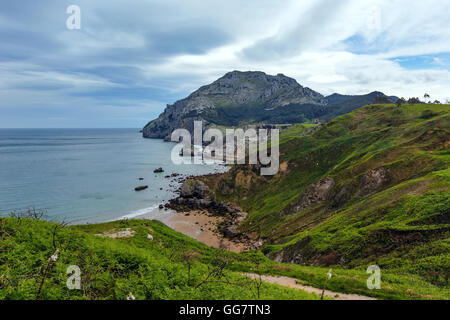 Spring sea coast lanscape with rocky cape and sandy beach (San Julian Beach, Liendo, Cantabria, Spain). Stock Photo