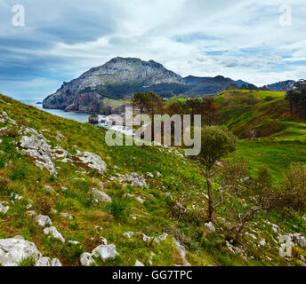 Spring sea coast lanscape with rocky cape and small bay (San Julian Beach, Liendo, Cantabria, Spain). Stock Photo