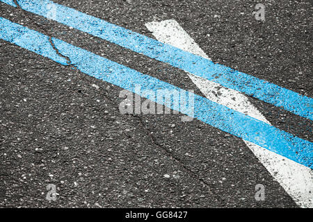 Blue double dividing line over one white on highway asphalt, closeup photo Stock Photo