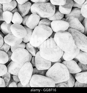 closeup of sidewalk made of many little round white pebble stones in square form Stock Photo