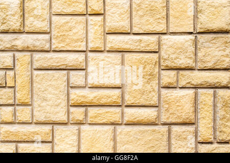 brown stone wall with grey concrete lines and very different rectangles Stock Photo