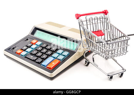 empty silver shopping trolley with old styled calculator on white background Stock Photo