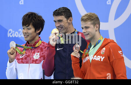 Rio De Janeiro, Brazil. 9th Aug, 2016. Gold medalist Michael Phelps (C) of the United States of America, silver medalist Japan's Masato Sakai (L), bronze medalists Hungary's Tamas Kenderesi show thier medals during the awarding ceremony for the men?s 200m butterfly final of swimming at the 2016 Rio Olympic Games in Rio de Janeiro, Brazil, on Aug. 9, 2016. Credit:  Qi Heng/Xinhua/Alamy Live News Stock Photo