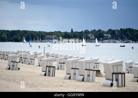 Berlin, Germany. 10th Aug, 2016. Dark clouds above empty beach chairs during temperatures of roughly 18 degrees at Wannsee beach in Berlin, Germany, 10 August 2016. PHOTO: RAINER JENSEN/dpa/Alamy Live News Stock Photo