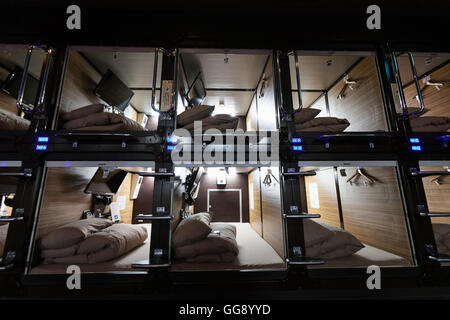 Anshin Oyado luxury capsule hotel located within 3-minutes of the busy Shinjuku station on August 7, 2016, Tokyo, Japan. The new take on the traditional Japanese capsule hotel offers larger capsules, free artificial hot springs & mist sauna, internet cafe and Wi-Fi. This hotel is male only and rates start at 5480 yen (54USD). Each of the hotel's 256 capsules is equipped with fire alarm, air conditioner, tablet computer and flat-screen TV. Public areas such as the hot springs bath, laundromat, clothing shop and snack and drinks vending machines are open 24 hours. The hotel's website is in Chine Stock Photo