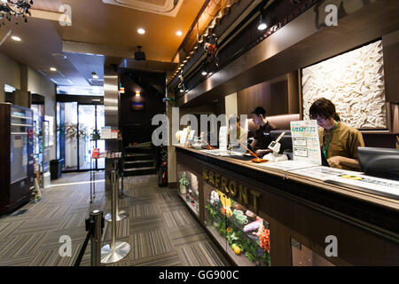 Anshin Oyado luxury capsule hotel located within 3-minutes of the busy Shinjuku station on August 7, 2016, Tokyo, Japan. The new take on the traditional Japanese capsule hotel offers larger capsules, free artificial hot springs & mist sauna, internet cafe and Wi-Fi. This hotel is male only and rates start at 5480 yen (54USD). Each of the hotel's 256 capsules is equipped with fire alarm, air conditioner, tablet computer and flat-screen TV. Public areas such as the hot springs bath, laundromat, clothing shop and snack and drinks vending machines are open 24 hours. The hotel's website is in Chine Stock Photo