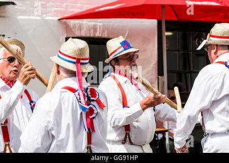 Broadstairs Folk Week. Traditional English Folk dancers, Hartley Morris side dancing and bashing poles together, Cotswold Style. Close up. Stock Photo