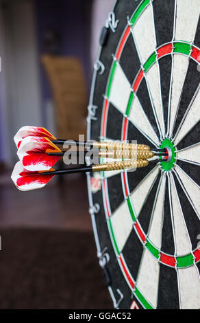 A dartboard close-up with three bullseye hits. Stock Photo
