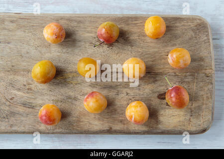 Fresh sweet mirabelle plums on a chopping board Stock Photo