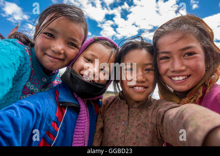 Ladies from Himalayas, female kids from Indian village of Langza in Spiti Valley at Himalayan Region taking group selfie Stock Photo