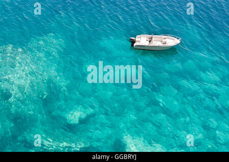 Speedboat anchored in turquoise water bay, high angle view Stock Photo