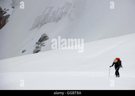 Lone woman Climber on snow fields on route up - Mera Peak High camp Stock Photo