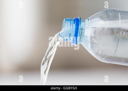 close up of water pouring from plastic bottle Stock Photo