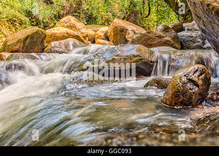 River current flowing through the rocks Stock Photo