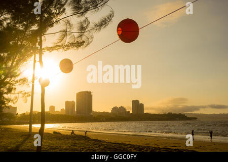 Setting sun over the city of Kota Kinabalu, Sabah, Malaysia Borneo, showing the beach and city skyline. Stock Photo