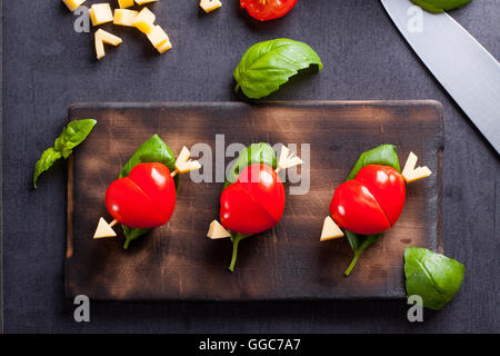 Marinated fillet with tomato heart shaped.  Appetizer for a party. Valentine's Day treat for your loved one. Stock Photo