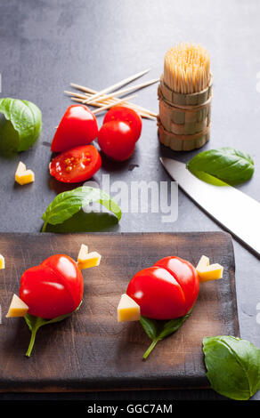 Marinated fillet with tomato heart shaped.  Appetizer for a party. Valentine's Day treat for your loved one. Stock Photo