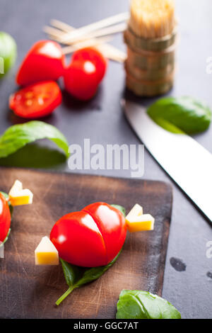 Marinated fillet with tomato heart shaped.  Appetizer for a party. Valentine's Day treat for your loved one. Stock Photo