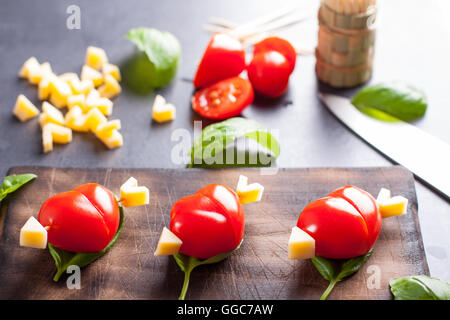 Marinated fillet with tomato heart shaped.  Appetizer for a party. Valentine's Day treat for your loved one. Stock Photo