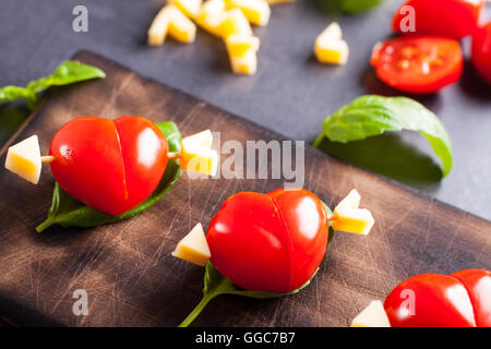 Marinated fillet with tomato heart shaped.  Appetizer for a party. Valentine's Day treat for your loved one. Stock Photo