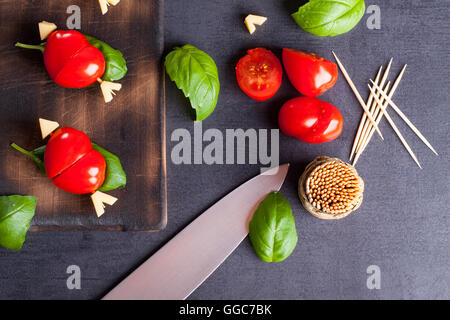 Marinated fillet with tomato heart shaped.  Appetizer for a party. Valentine's Day treat for your loved one. Stock Photo