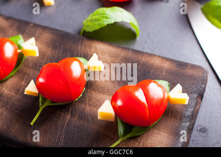 Marinated fillet with tomato heart shaped.  Appetizer for a party. Valentine's Day treat for your loved one. Stock Photo