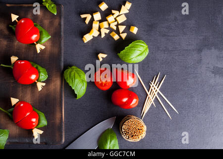 Marinated fillet with tomato heart shaped.  Appetizer for a party. Valentine's Day treat for your loved one. Stock Photo