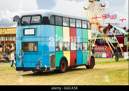 Multi-striped old omnibus parading at an English show Stock Photo