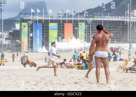 Brazil, Rio de Janeiro, scene on the beach, in the background a stadium for the Olympics at Copacabana Stock Photo