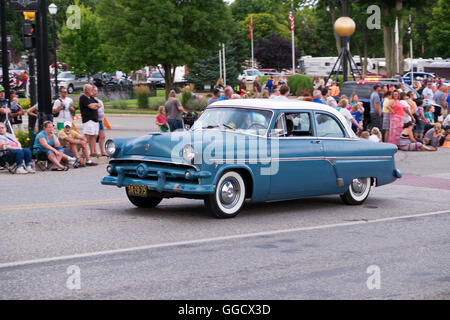 1954 Ford, 2-door, sedan participates in the 2016 Annual Cruz In parade in downtown Montague, Michigan. Stock Photo