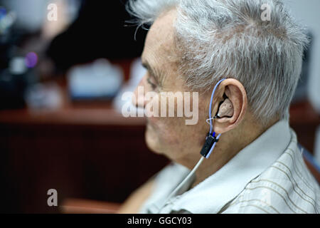 Senior citizen getting a hearing test with a hearing aid Stock Photo