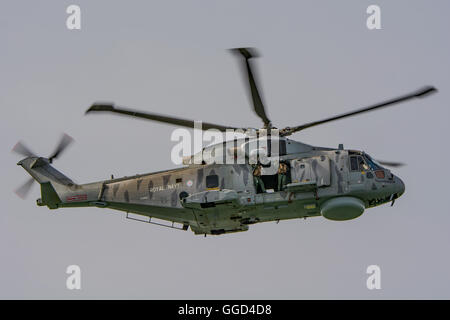 A Royal Navy Agusta Westland Merlin HM.2 helicopter from 814 Naval Air Squadron over Portsmouth Harbour, UK on the 5th August 2016. Stock Photo