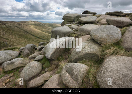 Dramatic rocky shapes on Crowden tower, Kinder Scout on a windy, summer day in the hills of the Peak District, Derbyshire. Stock Photo