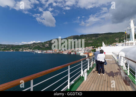 Couple on the deck of the cruise ship Arcadia, moored in the port of Bergen, Norway. Stock Photo