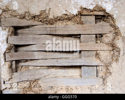 Detail of wattle and daub construction in a Tudor building showing lathes and the texture of the daub and surface lime plaster. Stock Photo